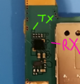 Location of TX pins on the board, according to the service manual (notice they're covered by the PCB mask)