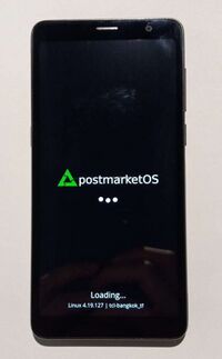 The TCL A3 with the postmarketOS splash screen running the downstream kernel.