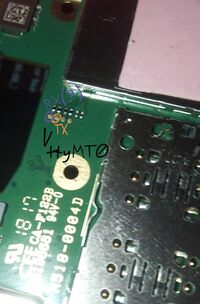 a vertical group of 4 small solder pads in the middle on back side of the main board of the phone. the upper one is probably a receive pin, the one below it is a transmit pin)