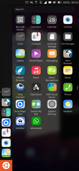Screenshot of the Lomiri desktop Ubuntu Touch launcher showing my installed OpenStore mobile Click apps - Barcode Reader, Calculator, Calendar, Camera, Clock, Contacts, External Storage, File Manager, Gallery, Media Player, Messaging, Mimi Browser, Morph Browser, Music, Music Recognition, Notes, Only Connect, OpenStore, OSM Scout Server, Phone, Pure Maps Slim, Switch My Slot, System Settings, Weather, Webber, Whats[App]Web.